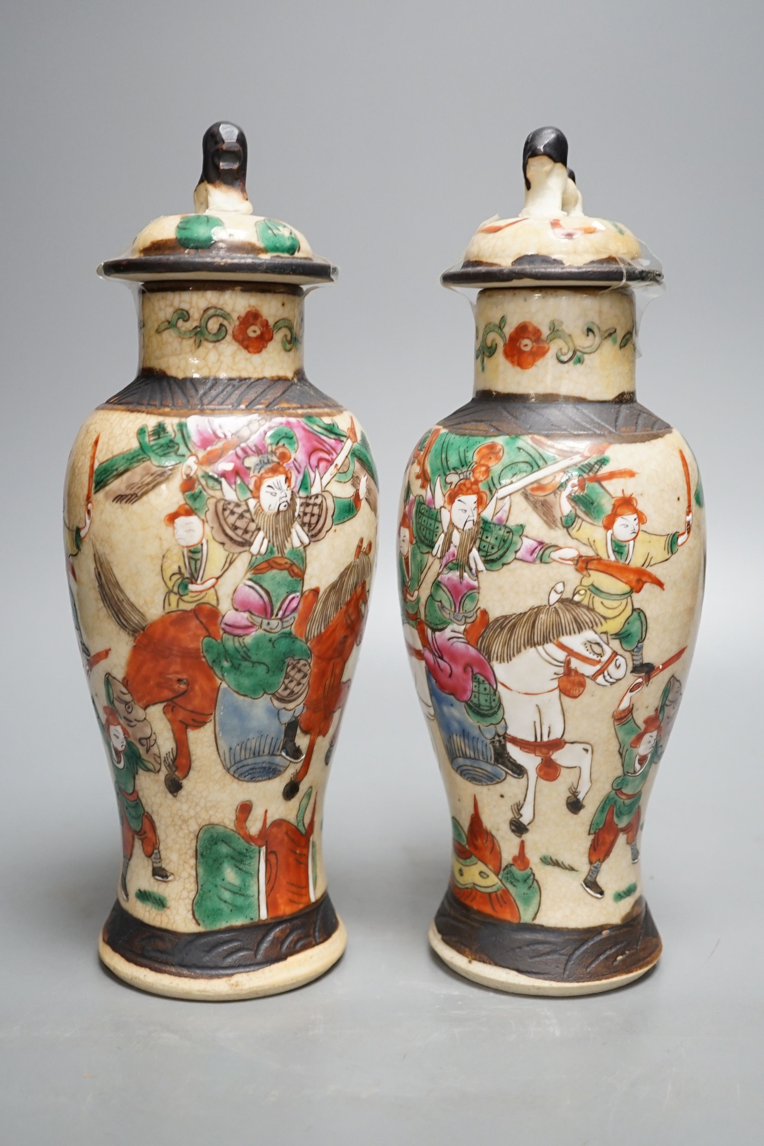 A pair of Chinese famille rose crackle glaze baluster jars and covers, 27cm.